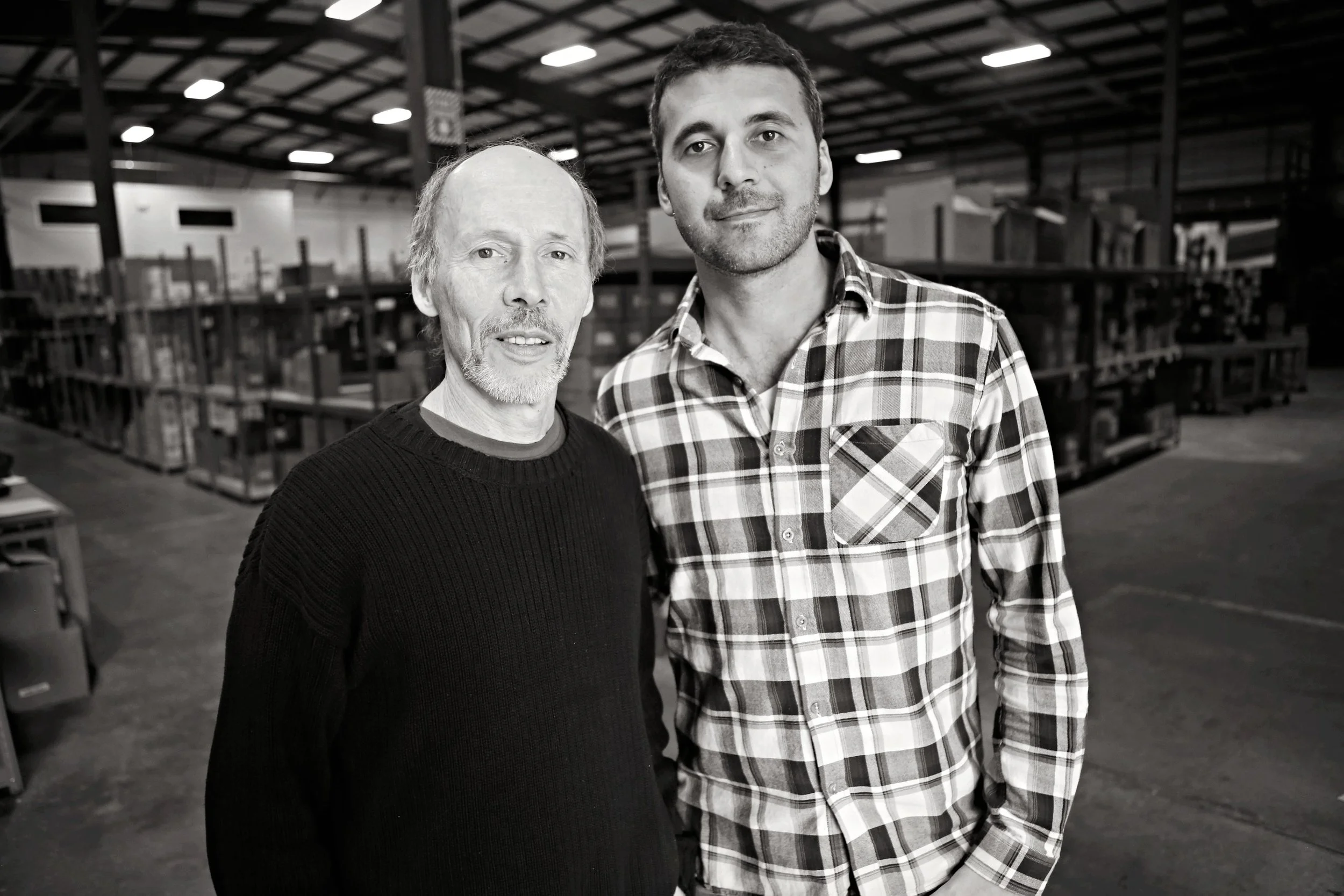 Two generations of the All Natural Distributors family in the Foxboro warehouse.